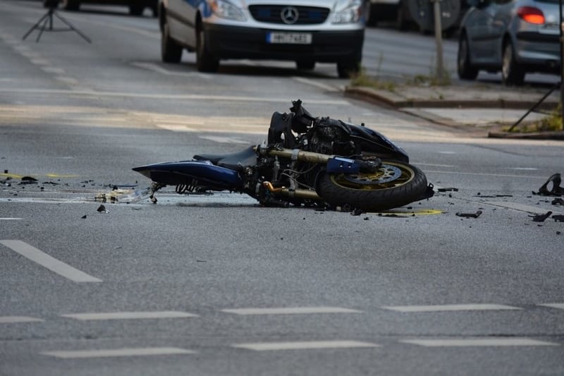 Motorcycle involved in accident laying sideways on the street